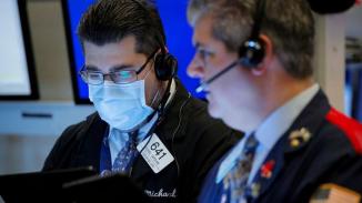 FILE PHOTO: Traders work on the floor of the NYSE in New York